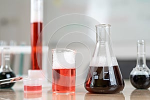 Chemical flasks with colorful liquids on laboratory desk