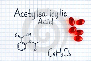 Chemical formula of Acetylsalicylic Acid with red pills. photo