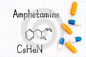 Chemical formula of Amphetamine with some pills photo