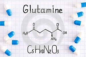 Chemical formula of Glutamine with some pills photo