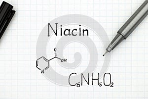 Chemical formula of Niacin with black pen