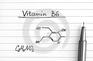 Chemical formula of Vitamin B6 with pen.