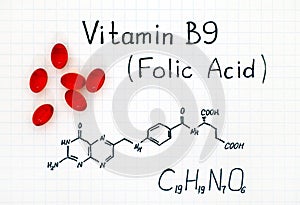 Chemical formula of Vitamin B9 Folic Acid with red pills.