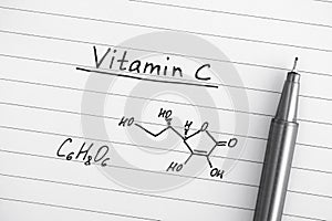 Chemical formula of Vitamin C with pen.