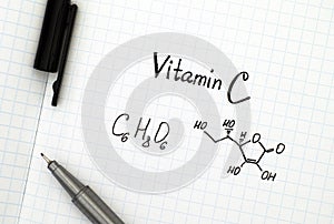 Chemical formula of Vitamin C with pen