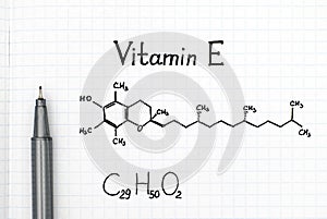 Chemical formula of Vitamin E with black pen