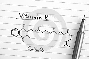 Chemical formula of Vitamin K with black pen.