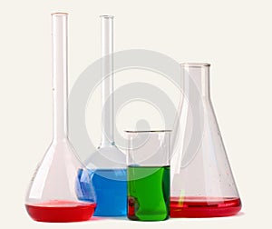 Chemical glassware with colorful liquids on white backg