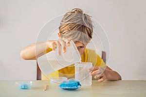 Chemical home tests. Tools for the home lab. the boy Explorer. Child is watching a chemical reaction. The young chemist