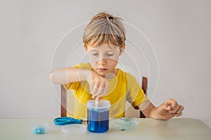 Chemical home tests. Tools for the home lab. the boy Explorer. Child is watching a chemical reaction. The young chemist