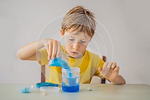 Chemical home tests. Tools for the home lab. the boy Explorer. Child is watching a chemical reaction. The young chemist