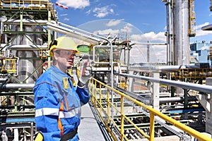 chemical industry plant - workers in work clothes in a refinery with pipes and machinery