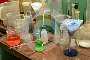 Chemical lab, you can see beakers and flasks on the table
