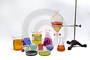 Chemical laboratory glassware with various colored liquids on table. Laboratory Research - Scientific Glassware For Chemical
