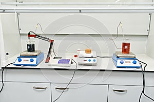 chemical laboratory with many equipment stands on a white table