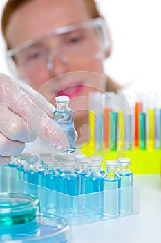 Chemical laboratory scientist woman with bottles