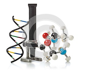 Chemical molecule and DNA structure model with old microscope over white background
