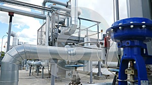 Chemical plant pipelines. Heavy industry. Large industrial tubing and piping inside central heating plant. Steam heat