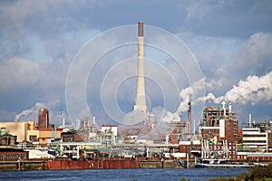 Chemical plant at a river by day