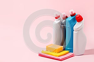 Chemical poisoned cleaning supplies bottles isolated on pink pastel background. Hard shadow, trendy shot, copy space for your adds