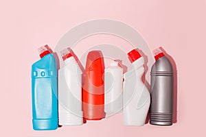 Chemical poisoned cleaning supplies bottles isolated on pink pastel background. Hard shadow, trendy shot, copy space for your adds