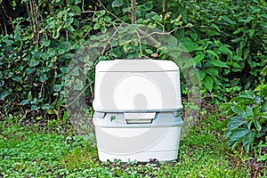 Chemical portable toilet. Single portable toilet standing on summer green nature