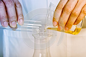 Chemical reagent pouring and mixing, Laboratory and science experiments, Oil formulating the chemical