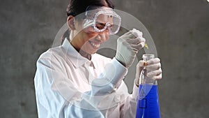 Chemical research scientist working in the lab with colorful liquids