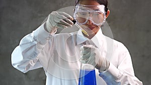 Chemical research scientist working in the lab with colorful liquids