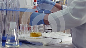 Chemical research scientist working in the lab with colorful liquids