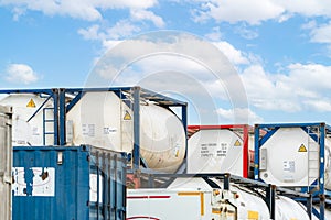 Chemical tank container. ISO tank container for chemical delivery. Bulk liquid transport. Chemical company. Container freight area