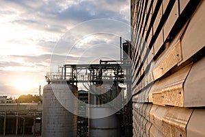 Chemical tanks in petrochemical industry plant at sunrise