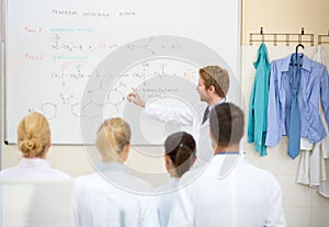Chemical teacher explain lesson to students