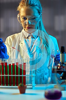 Chemical technician working at night in the lab