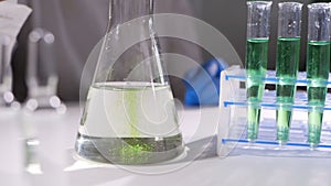 Chemical test in laboratory, Scientist performing chemical liquid test in laboratory.