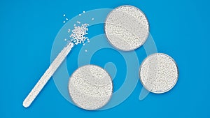 Chemical test tube and round bowls with white polymer granules