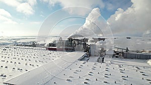 Chemical wood production, smoke emissions and environmental pollution. Winter sunshine clear snow. Aerial view.