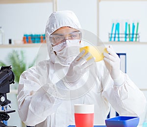 Chemist checking and testing plastic dishes