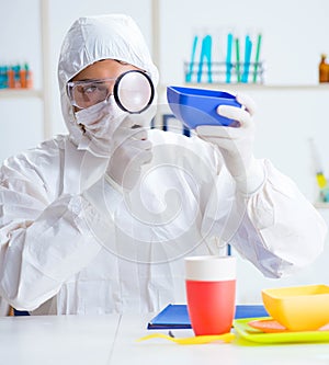 Chemist checking and testing plastic dishes