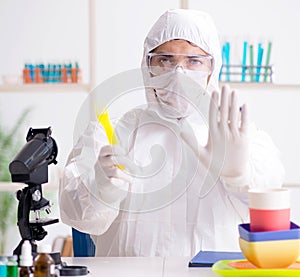 Chemist checking and testing plastic dishes