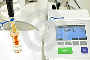 A chemist conducts a study of the stiffness of the solution. Laboratory PH measurement. A device for measuring PH
