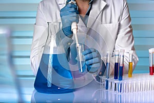 Chemist engineer working with fluids in laboratory