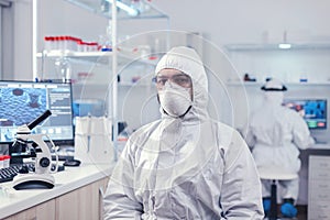 Chemist feeling tired from work for a long time in laboratory photo
