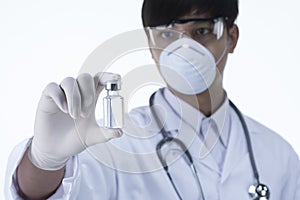 Chemist in laboratory checking test tubes.