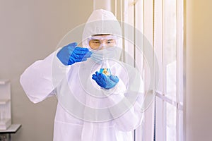 Chemist man smelling test medical chemicals sample in glass volumetric flask at laboratory