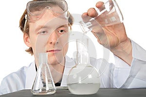 Chemist pours liquid in flask