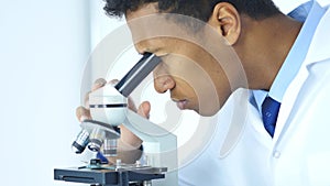 Chemist, Scientific Reseacher using Microscope in Laboratory