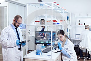 Chemist scientists doing vacine study in busy lab