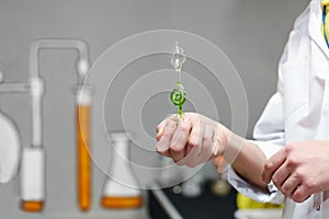Chemist shows the flask with a green liquid inside