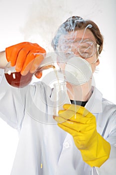 Chemist in smoke pours liquid in a flask